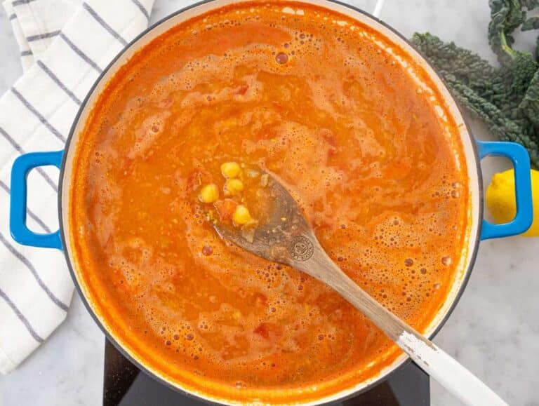 Step 2 Chickpeas tomatoes and broth simmering in a skillet.