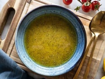 Step 2 Homemade honey mustard dressing whisked in a blue bowl.