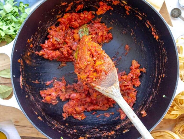 Step 2 Onion carrot celery garlic oregano and tomato paste sautéing in olive oil for mushroom pasta.