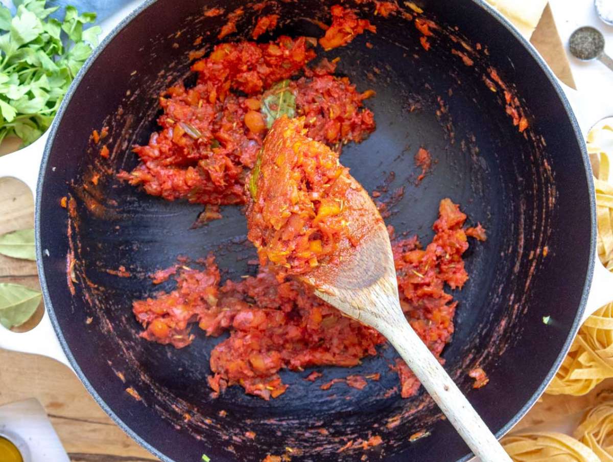 Step 2 Onion carrot celery garlic oregano and tomato paste sautéing in olive oil for mushroom pasta.