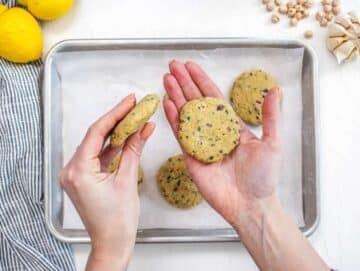 Step 2 Shaping chickpea mixture into small patties on a tray ready to cook.
