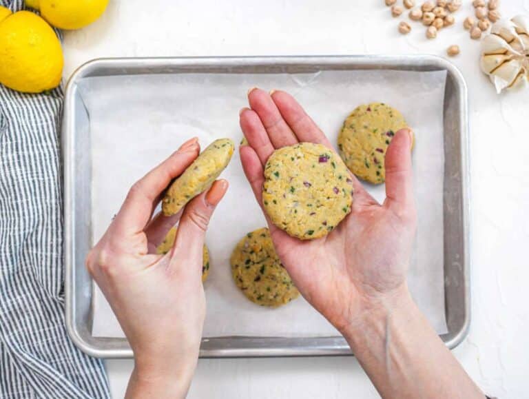 Step 2 Shaping chickpea mixture into small patties on a tray ready to cook.