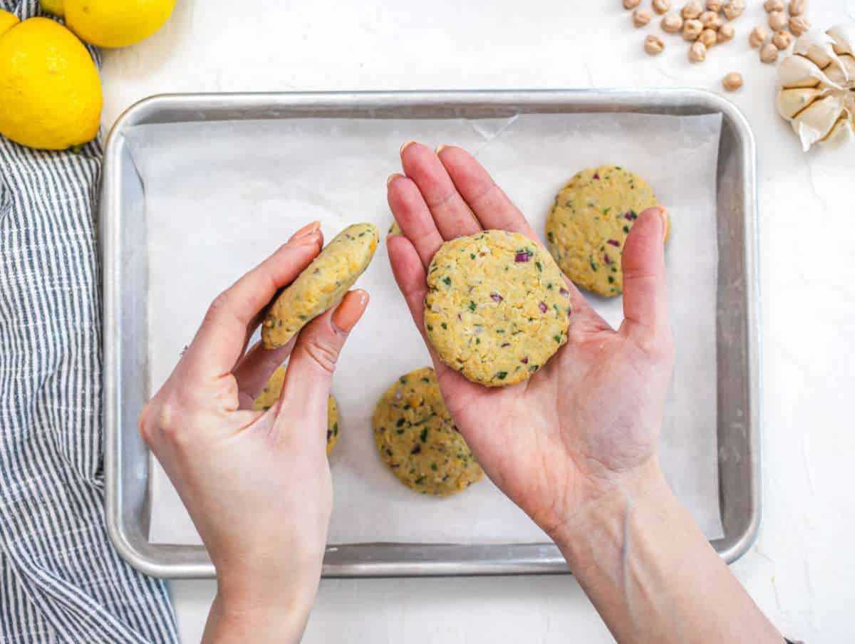 Step 2 Shaping chickpea mixture into small patties on a tray ready to cook.
