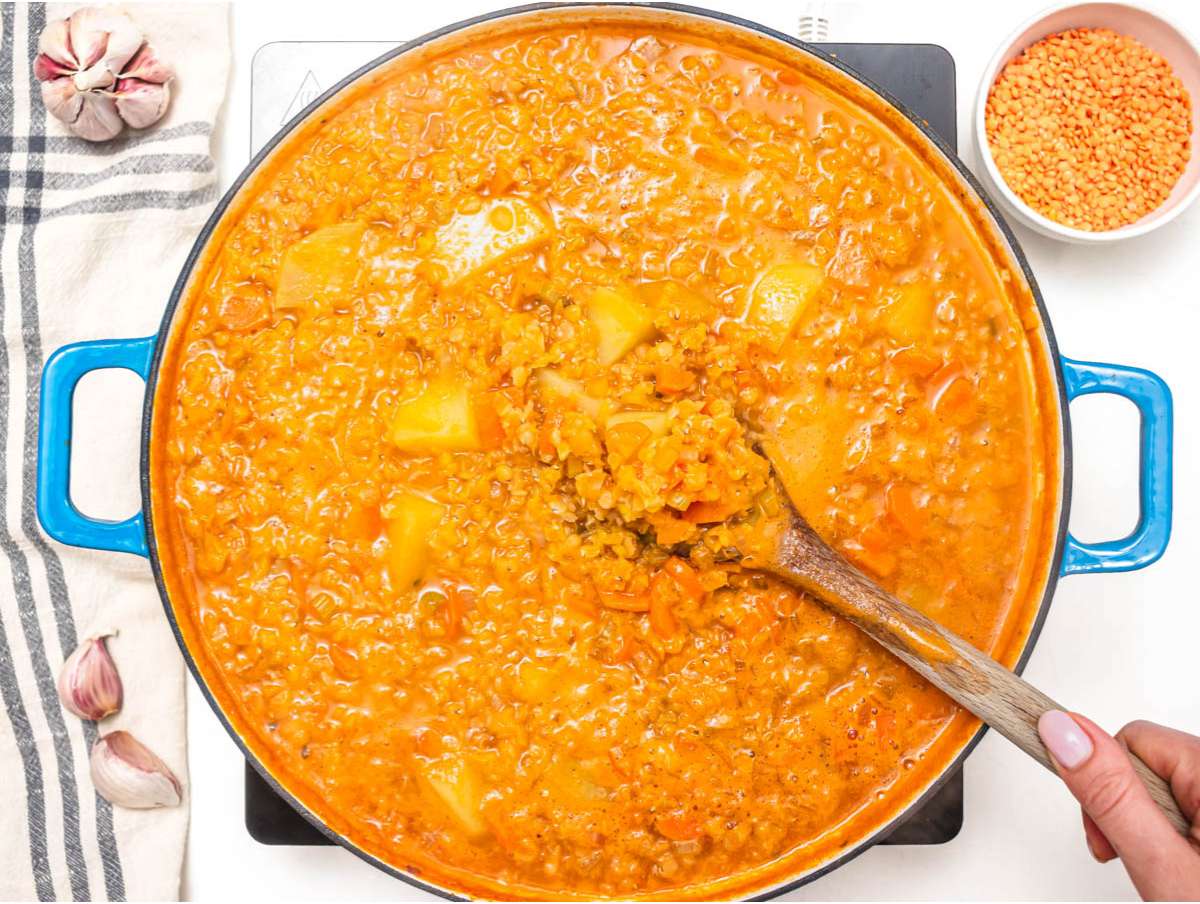 Step 2 diced potatoes vegetable broth and red lentils added to pot for lentil soup.