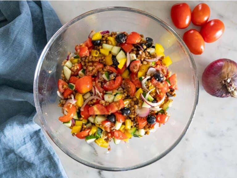 Step 3 Chopped cucumber tomatoes onion olives and bell pepper mixed with marinated lentils.