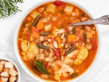 Step 3 Finished Mediterranean vegetable soup in pot simmering with colorful vegetables and hearty texture.