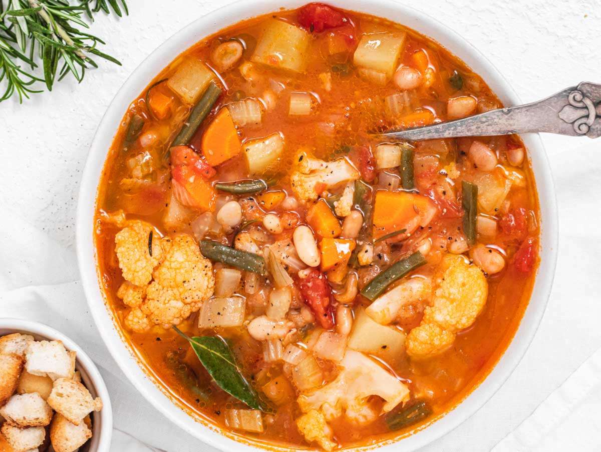Step 3 Finished Mediterranean vegetable soup in pot simmering with colorful vegetables and hearty texture.