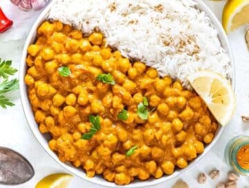 Step 3 Serve coconut curry with chickpeas in bowl with rice cilantro and yogurt topping.