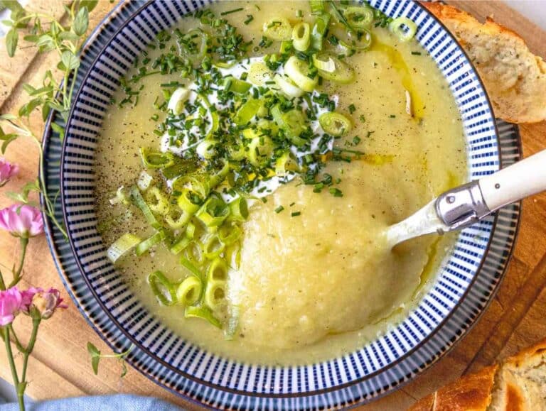 Step 4 Finished potato soup in bowls garnished with Greek yogurt cracked pepper and chives.
