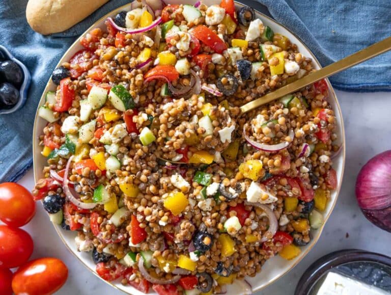 Step 4 Greek lentil salad with feta crumbled in served on a large platter.