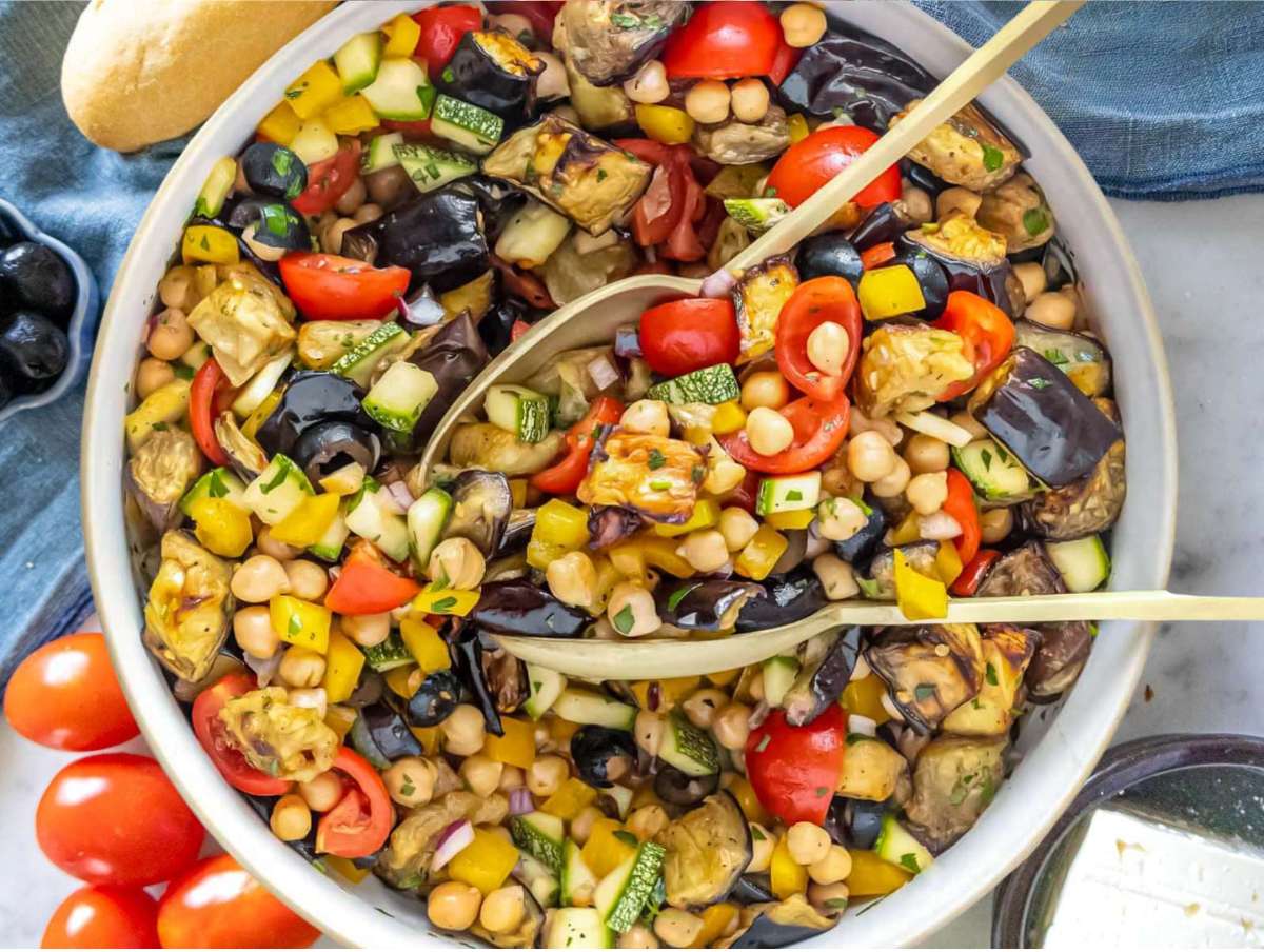 Step 4 Mixing all ingredients for chickpea eggplant salad in a white serving bowl.