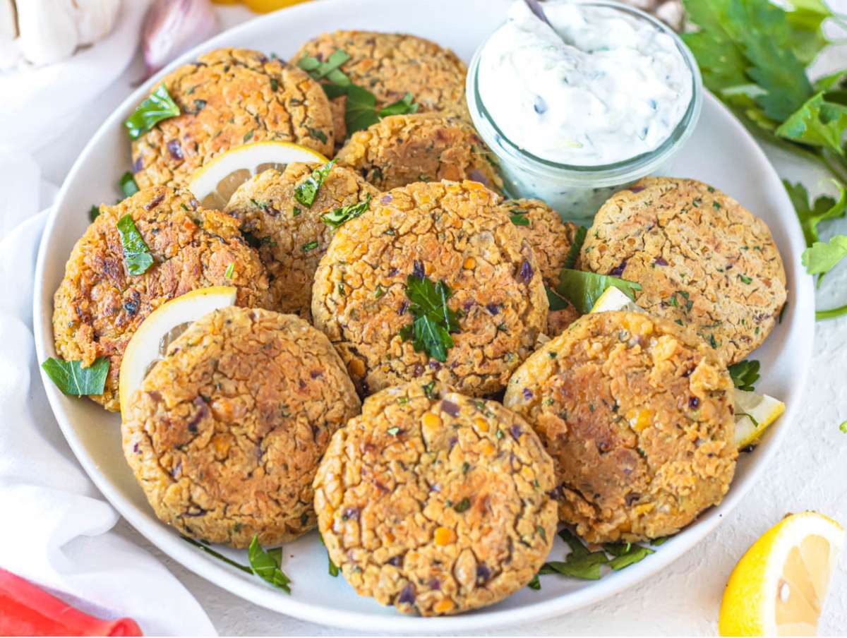 Step 4 Serving chickpea patties on platter with lemon parsley and dipping sauce.