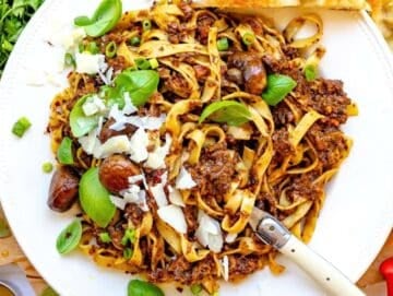 Step 5 Mediterranean mushroom pasta served on a plate with fresh basil and parmesan.
