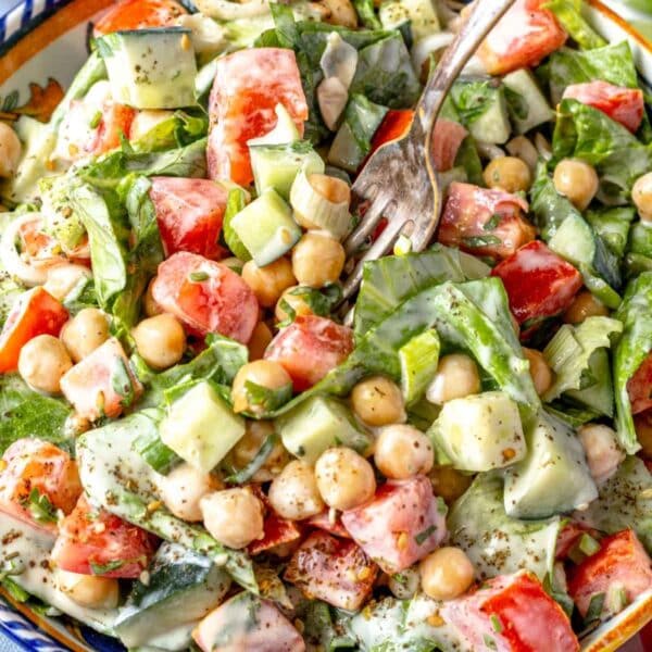 Chopped chickpea salad with healthy creamy tahini dressing served as a wholesome lunch idea.