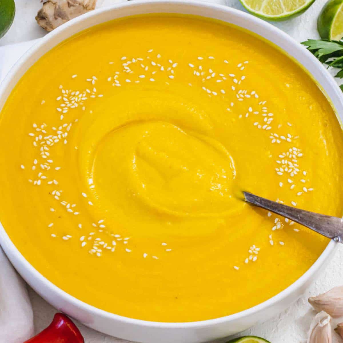 Cozy fall dinner with creamy coconut pumpkin soup in a rustic kitchen setting.