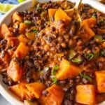 Easy one pot black bean chili in a bowl topped fresh cilantro and lime.