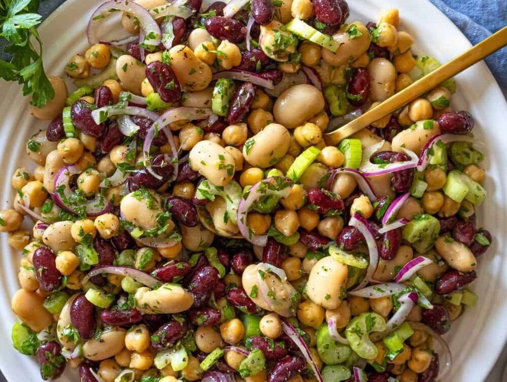 Step 3 Finished 3 bean salad recipe chilling in bowl ready to serve with parsley.