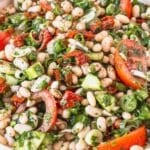 Fresh dense white bean salad with olive oil drizzle and crusty bread on the side.