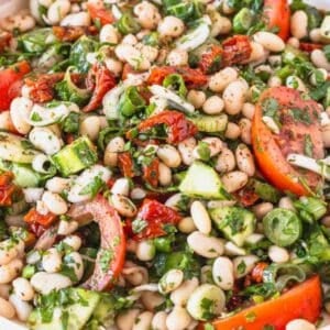 Fresh dense white bean salad with olive oil drizzle and crusty bread on the side.
