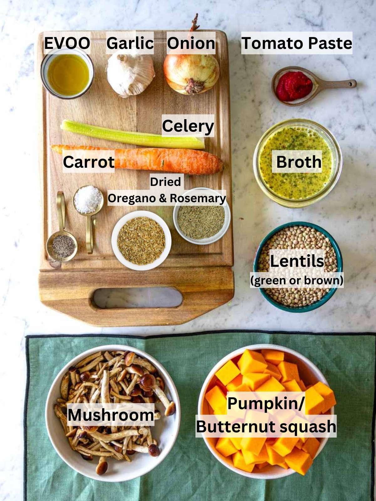 Fresh ingredients for lentil pumpkin stew including pumpkin lentils carrots mushrooms and herbs.