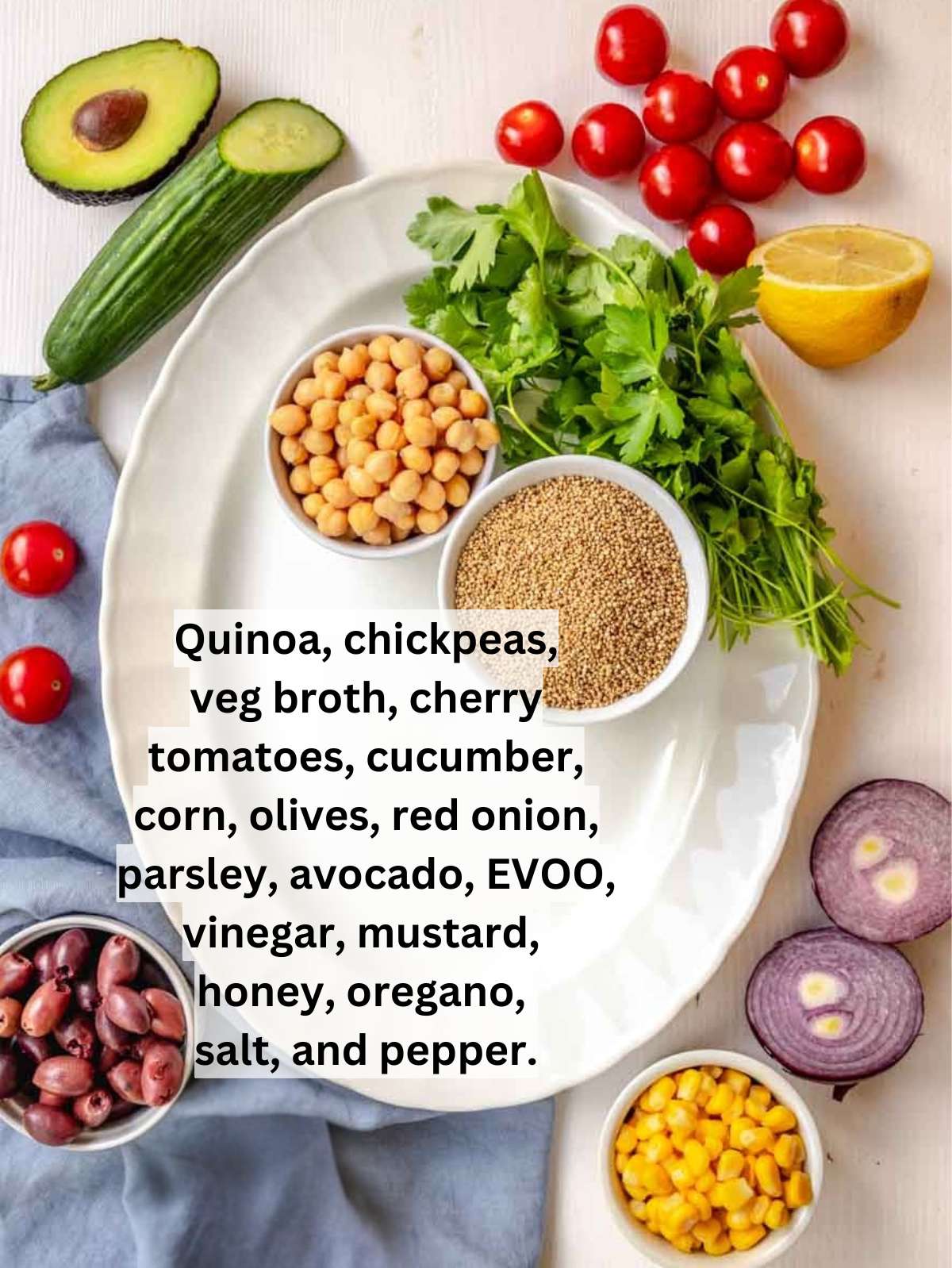 Ingredients for Mediterranean quinoa salad including quinoa chickpeas tomatoes cucumber and avocado.