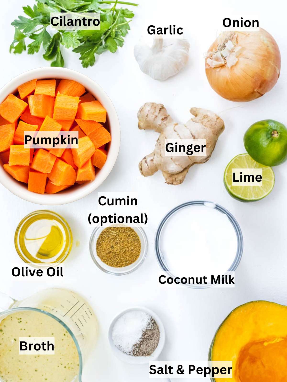 Ingredients for coconut pumpkin soup with pumpkin onion garlic ginger coconut milk and lime.