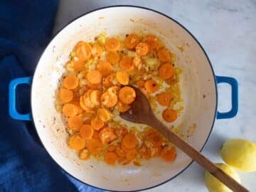 Step 1 Cooking onions carrots and garlic in pot to start Mediterranean chickpea soup base.