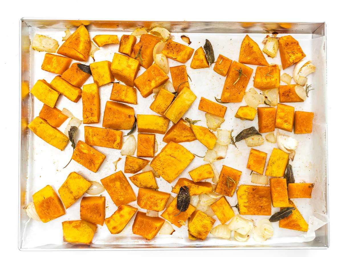 Step 1 Roasted pumpkin onion and garlic golden and caramelized on a baking sheet.