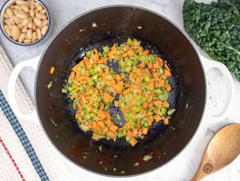 Step 1 Sautéing onion, carrot, and celery in olive oil for Mediterranean kale soup flavor base.