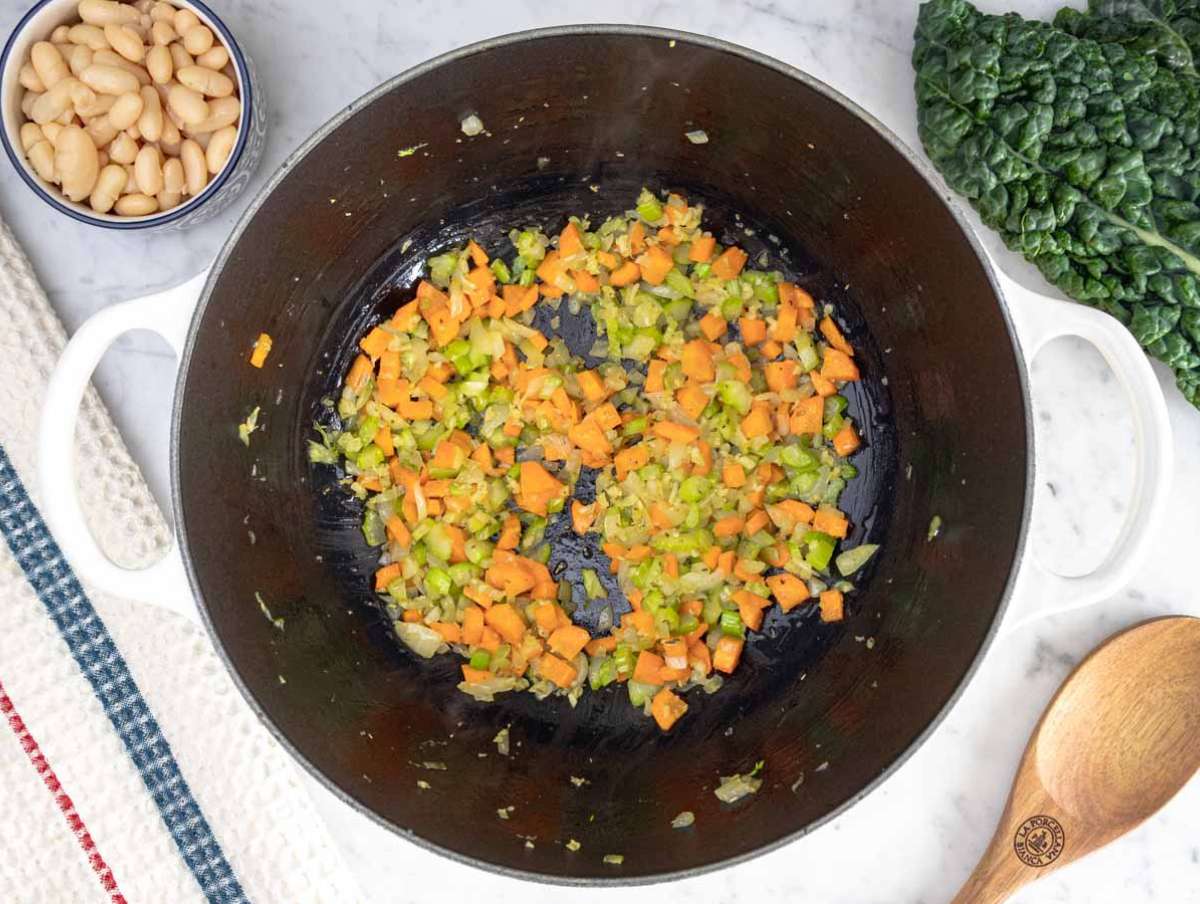 Step 1 Sautéing onion, carrot, and celery in olive oil for Mediterranean kale soup flavor base.