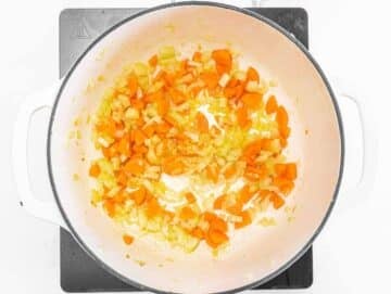 Step 1 Sautéing onion, carrot, and celery in olive oil for the soup base.