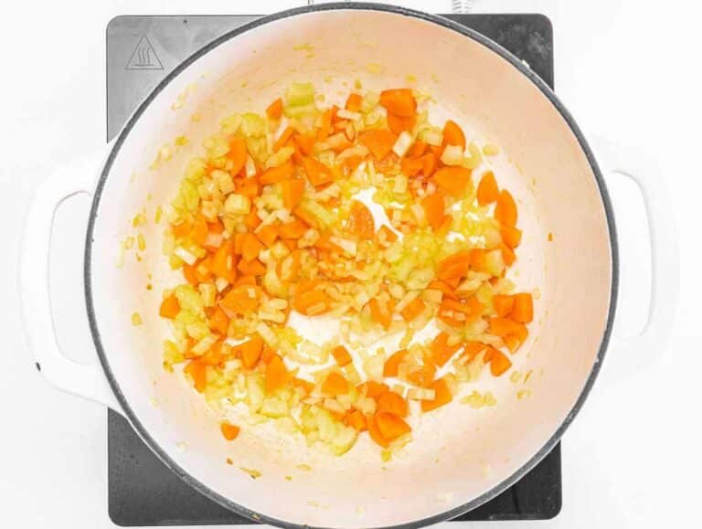 Step 1 Sautéing onion, carrot, and celery in olive oil for the soup base.