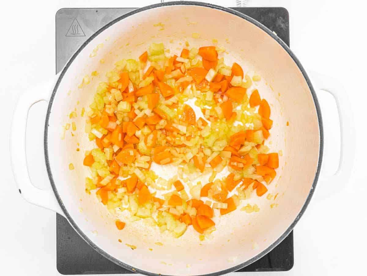 Step 1 Sautéing onion, carrot, and celery in olive oil for the soup base.