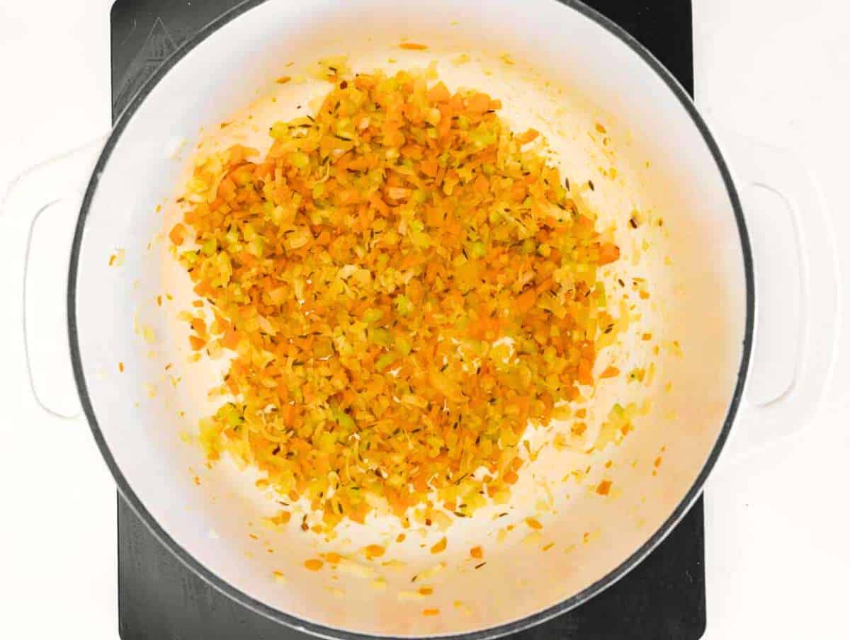 Step 1 Sauteฬing onion, celery, and carrot in olive oil for the soup base.