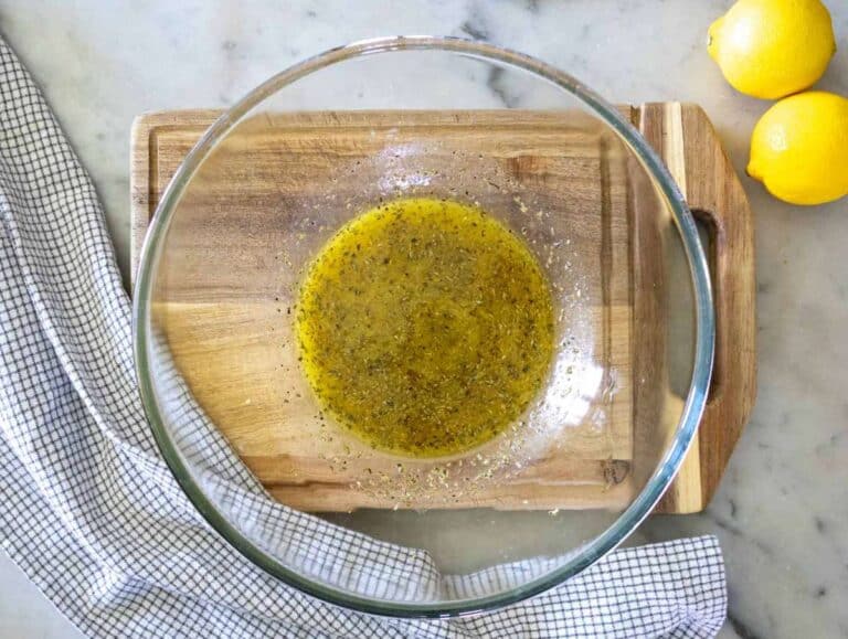 Step 1 Whisking dressing ingredients together in a bowl for Mediterranean bean salad.