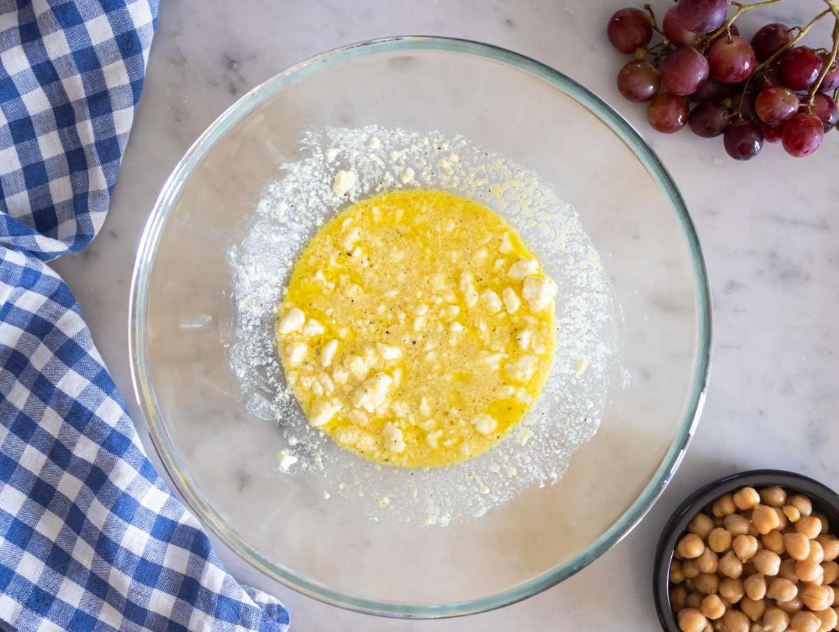 Step 1 Whisking olive oil lemon honey mustard and feta to make creamy dressing.