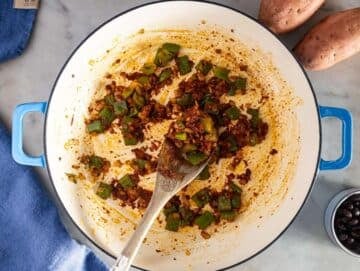 Step 1 image – Sautéing onion, bell pepper, garlic, and spices for the black bean chili base.