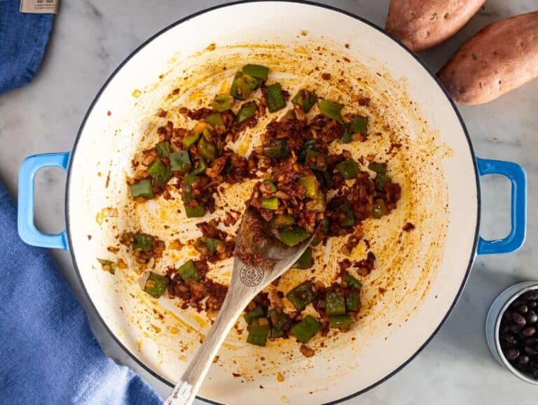Step 1 image – Sautéing onion, bell pepper, garlic, and spices for the black bean chili base.