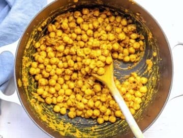 Step 2 Chickpeas added to skillet with spices salt and pepper for chickpea masala.