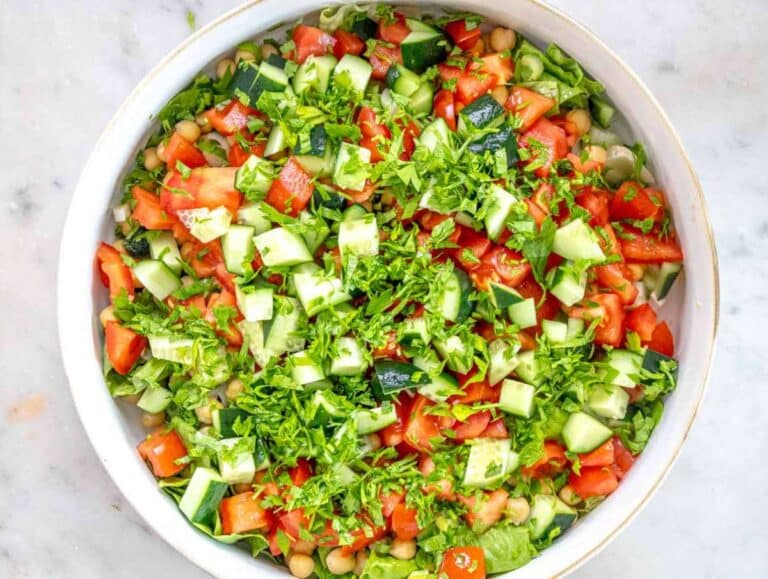 Step 2 Chopping lettuce cucumber tomato parsley and green onions for fresh salad base.
