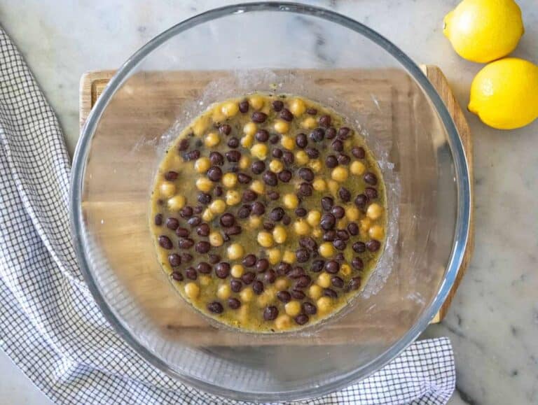 Step 2 Marinating chickpeas and black beans in dressing for flavor.