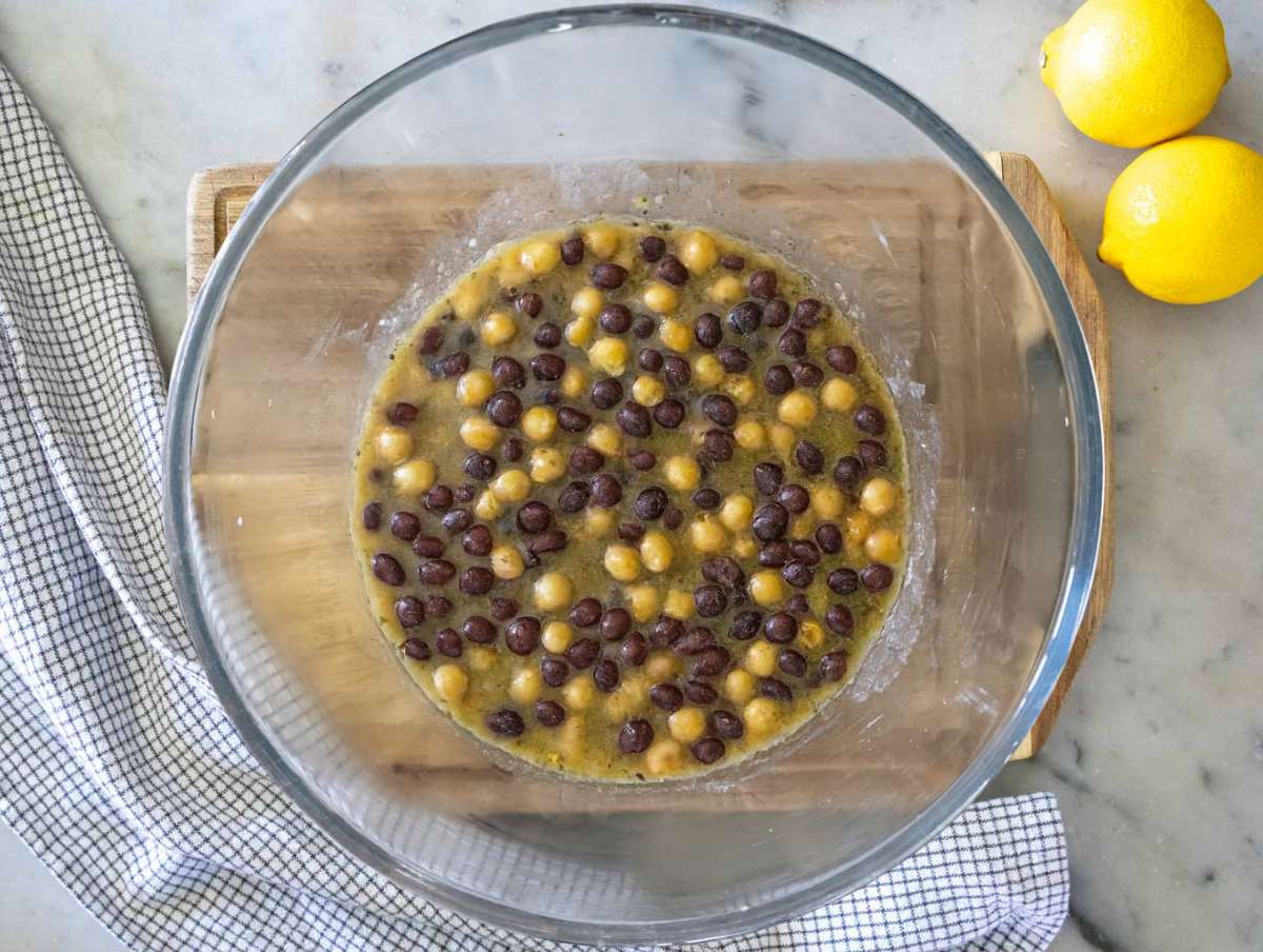 Step 2 Marinating chickpeas and black beans in dressing for flavor.