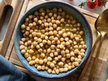 Step 2 Marinating chickpeas in dressing with olive oil mustard lemon and oregano for extra flavor.