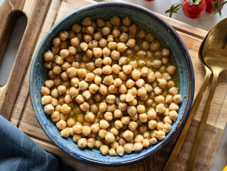 Step 2 Marinating chickpeas in dressing with olive oil mustard lemon and oregano for extra flavor.