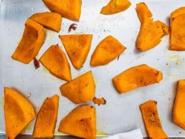 Step 2 Roasted pumpkin pieces golden and tender on a baking tray fresh from the oven.