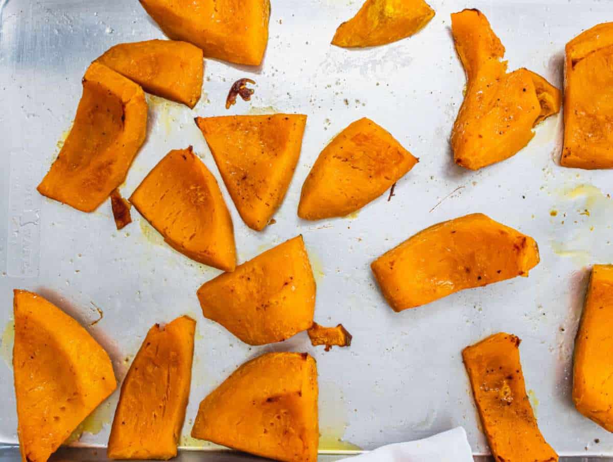Step 2 Roasted pumpkin pieces golden and tender on a baking tray fresh from the oven.