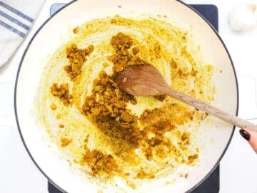 Step 2 Spices toasting in pan with onion ginger and garlic releasing aroma for butternut squash chickpea curry.