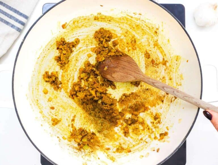 Step 2 Spices toasting in pan with onion ginger and garlic releasing aroma for butternut squash chickpea curry.
