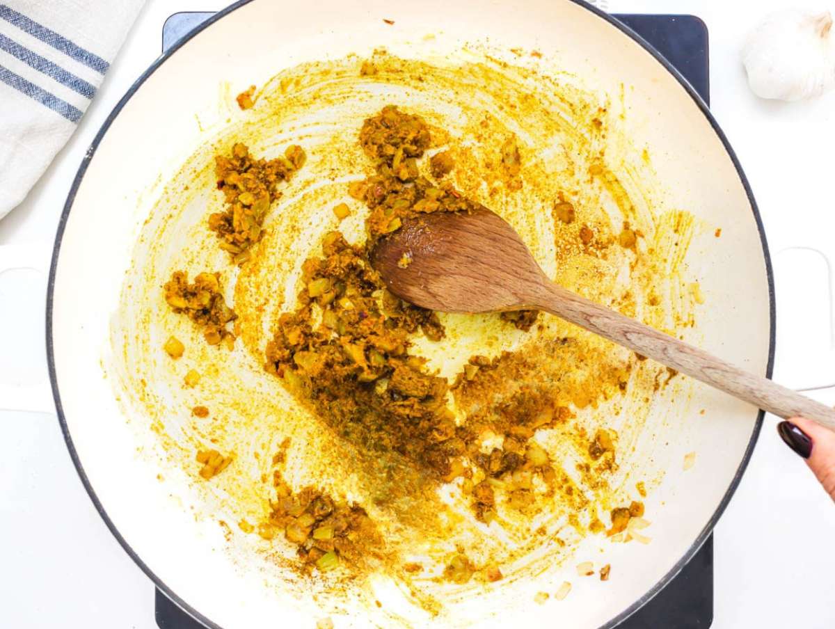 Step 2 Spices toasting in pan with onion ginger and garlic releasing aroma for butternut squash chickpea curry.