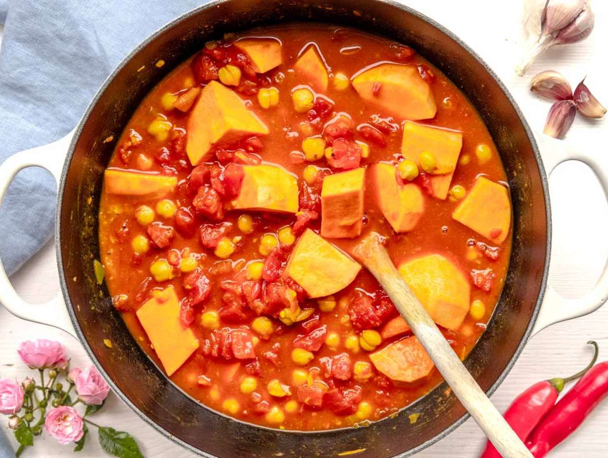 Step 2 – Simmering chickpeas sweet potatoes and tomatoes in pot for creamy turmeric chickpea stew.